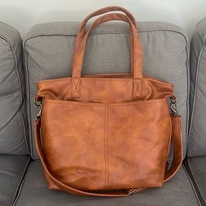 Vegan leather & features durable handles and multiple pockets for your laptop.